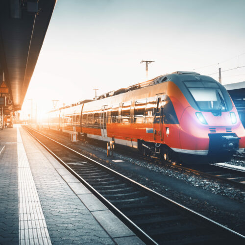 Modern,High,Speed,Red,Commuter,Train,At,The,Railway,Station Modern,High,Speed,Red,Commuter,Train,At,The,Railway,Station
